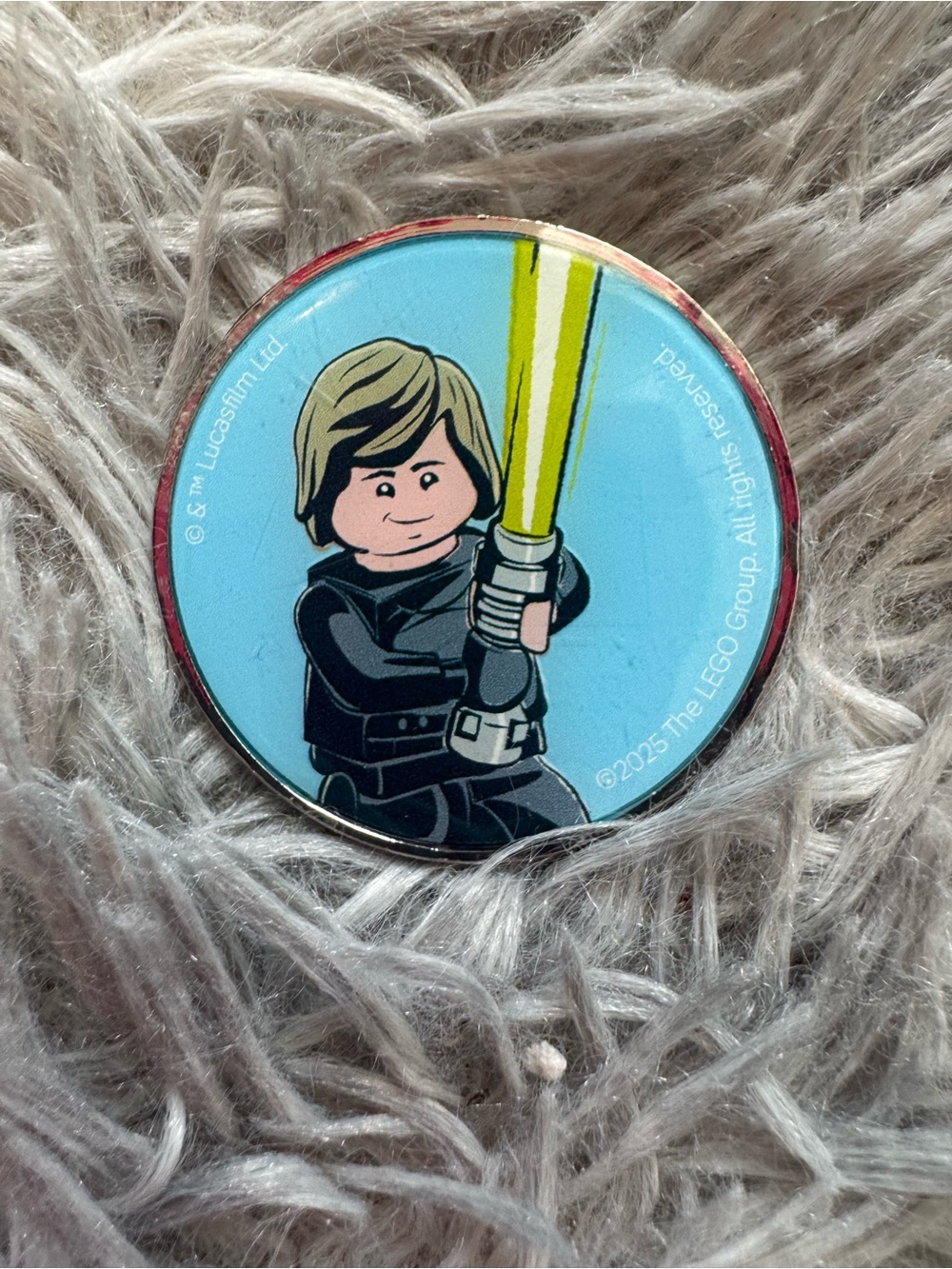 Lego Star Wars Minifigure Medallion with Yellow Lightsaber and Blue Background